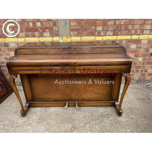 315 - A compact walnut cased Kemble Miniature piano 133wide