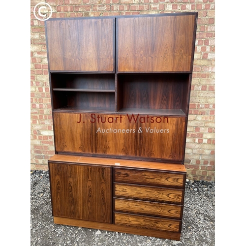 32 - A danish rosewood sideboard / bureau with a fitted interior over four drawers and a cupboard to the ... 