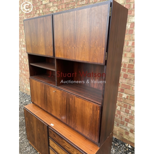 32 - A danish rosewood sideboard / bureau with a fitted interior over four drawers and a cupboard to the ... 