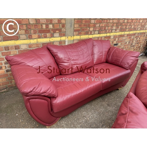 324 - A large modern red leather three piece lounge suite consisting of three starter sofa, two seater sof... 