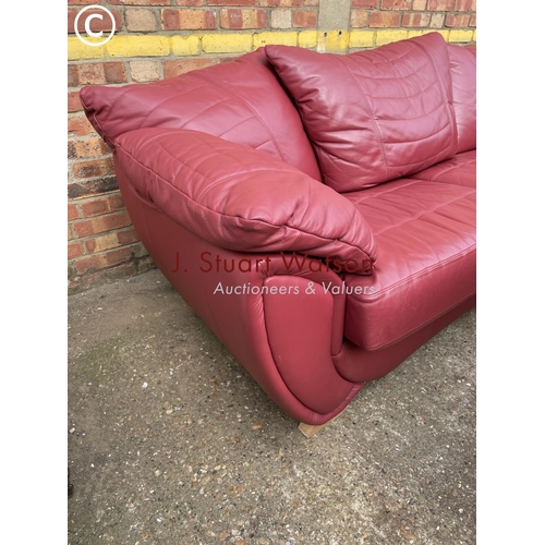 324 - A large modern red leather three piece lounge suite consisting of three starter sofa, two seater sof... 