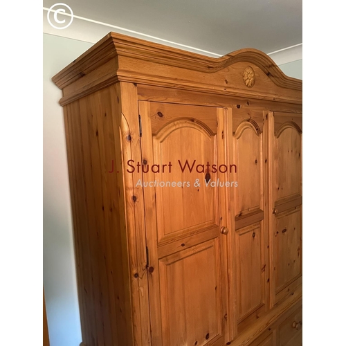 326 - A large solid pine double wardrobe on five drawer base 145x60x210