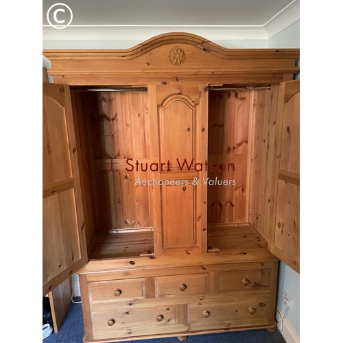 326 - A large solid pine double wardrobe on five drawer base 145x60x210