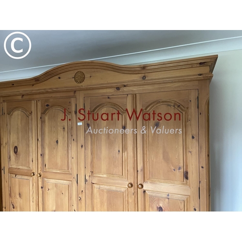 327 - A solid pine quadruple wardrobe on two drawer base 190x60x210