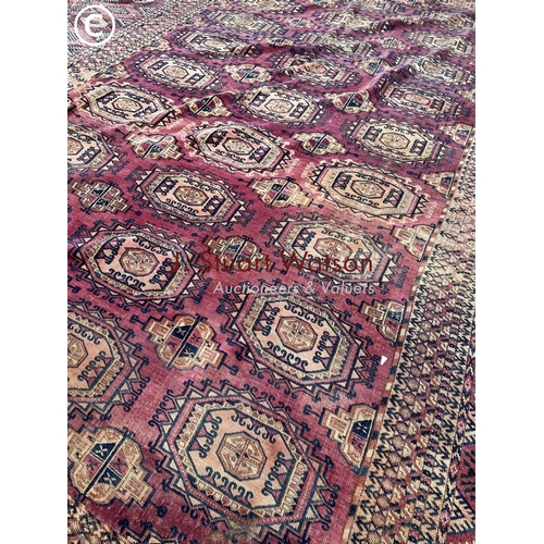 331 - A large worn oriental pattern carpet 420x220