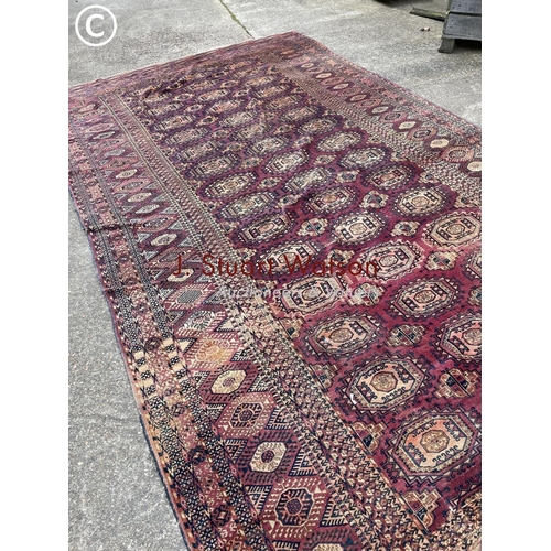 331 - A large worn oriental pattern carpet 420x220