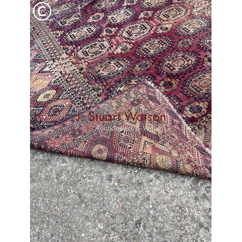 331 - A large worn oriental pattern carpet 420x220