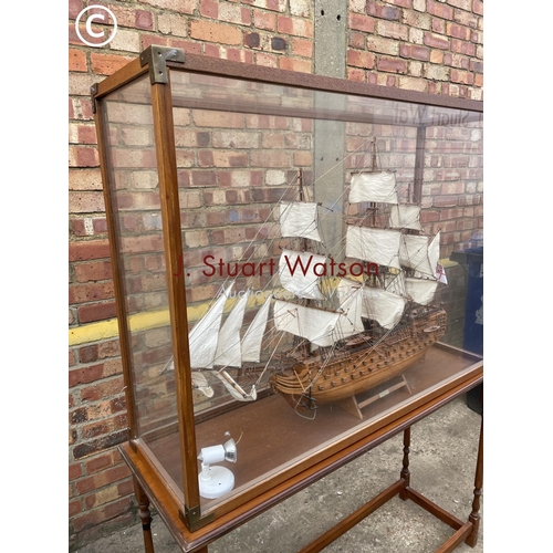 332 - A large glass cased model on stand of HMS Victory 120x40x165