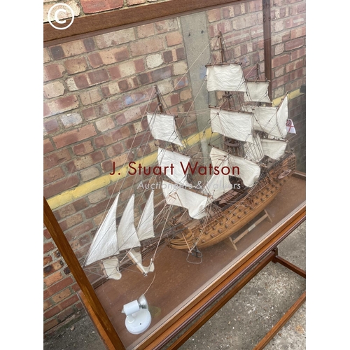 332 - A large glass cased model on stand of HMS Victory 120x40x165