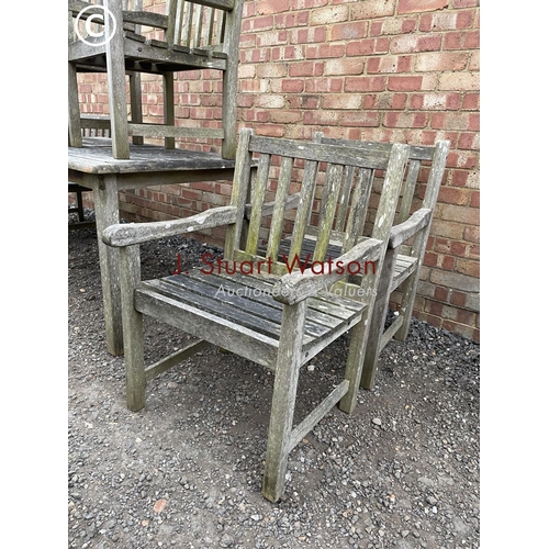 334 - A good quality hardwood garden table together with six matching carver chairs 150x90