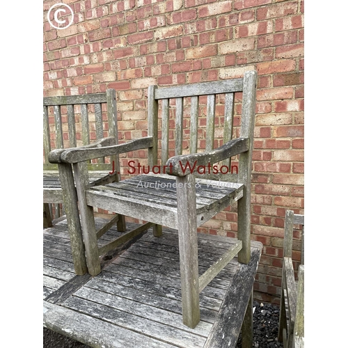 334 - A good quality hardwood garden table together with six matching carver chairs 150x90