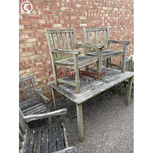 334 - A good quality hardwood garden table together with six matching carver chairs 150x90