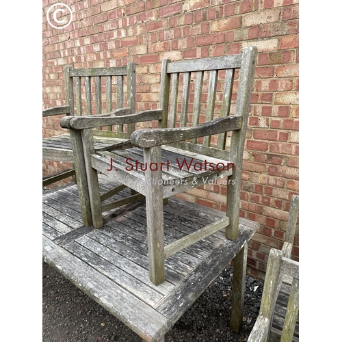 334 - A good quality hardwood garden table together with six matching carver chairs 150x90