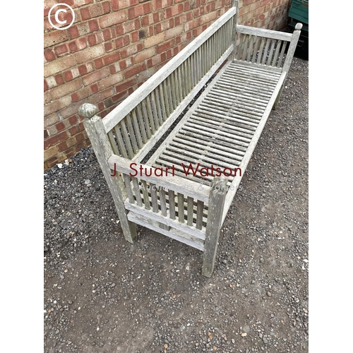 335 - A long hardwood country house style garden bench 190cm