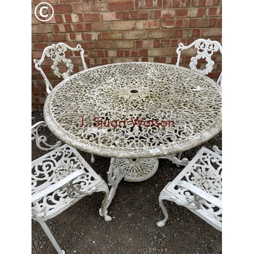 339 - An ornate circular aluminum white painted garden table together with four carver chairs 110 cm diame... 