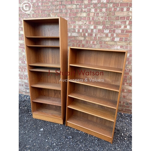 34 - A mid century danish style teak bookcase together with another teak bookcase