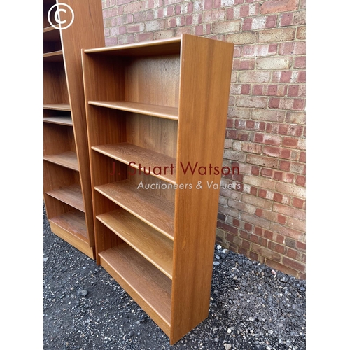 34 - A mid century danish style teak bookcase together with another teak bookcase