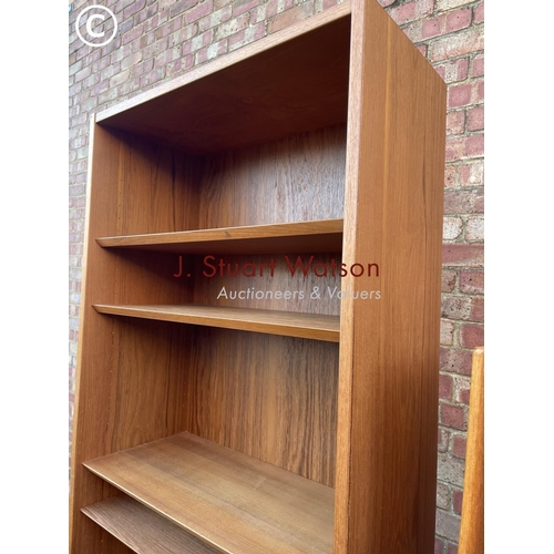 34 - A mid century danish style teak bookcase together with another teak bookcase