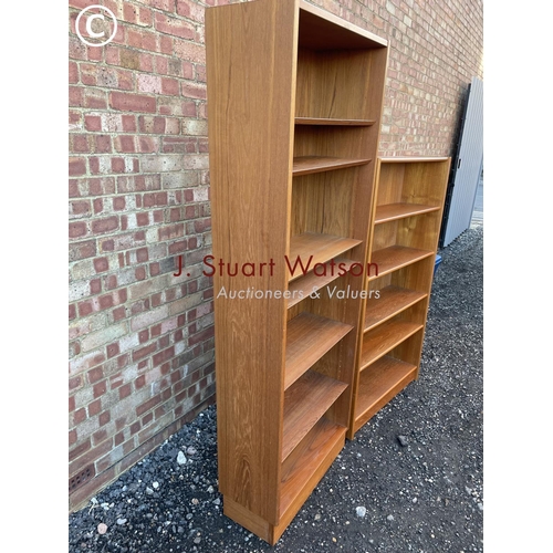 34 - A mid century danish style teak bookcase together with another teak bookcase