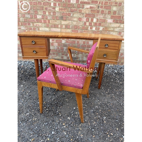 358 - A mid cemtury teak four drawer desk of curved form together with matching carver chair