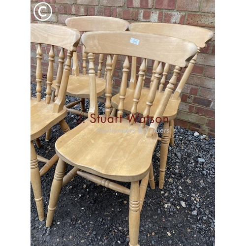 369 - A set of four solid pine kitchen chairs