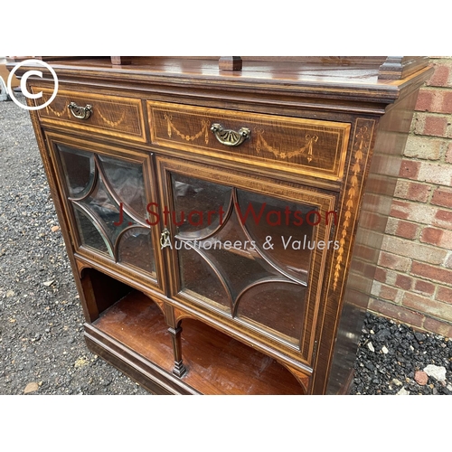 4 - An Edwardian mahogany inlaid cheffioner cabinet with a mirror back