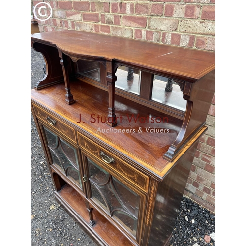 4 - An Edwardian mahogany inlaid cheffioner cabinet with a mirror back