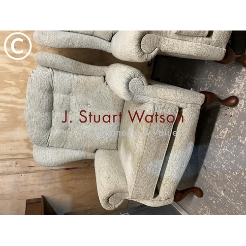 411 - A pair of modern oatmeal upholstered wing back armchairs