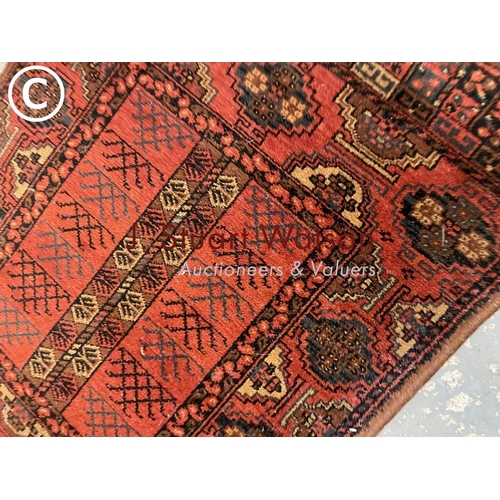 418 - A red / brown pattern runner rug