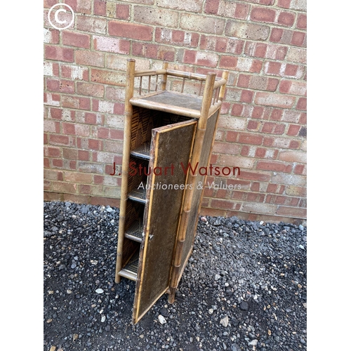 43 - A small antique bamboo cupboard with internal shelves