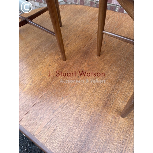 5 - A g plan mid century extending teak dining table together with a set of six g plan chairs with cross... 