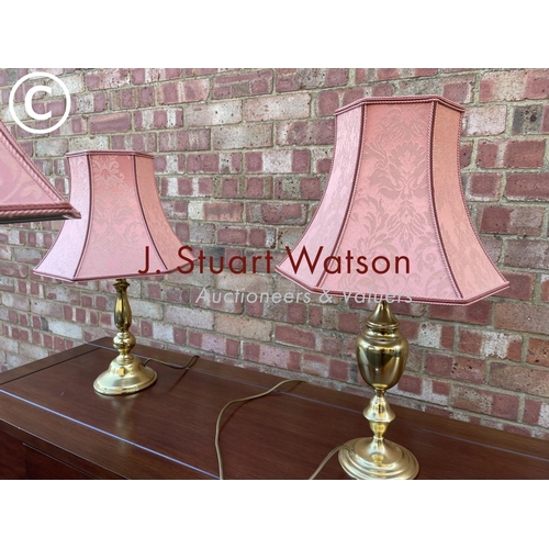 50 - A brass standard lamp together with two matching table lamps