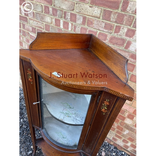 53 - An Edwardian inlaid corner cabinet