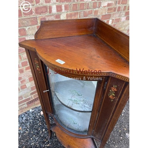 53 - An Edwardian inlaid corner cabinet