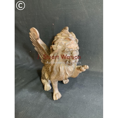 535 - Heavy Cast iron winged lion figure, height 30cms