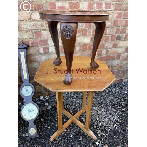 55 - An Edwardian bathroom cabinet together with two barometers, a light oak table and a carved stool