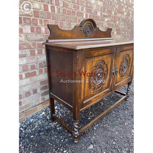 56 - A carved oak sideboard