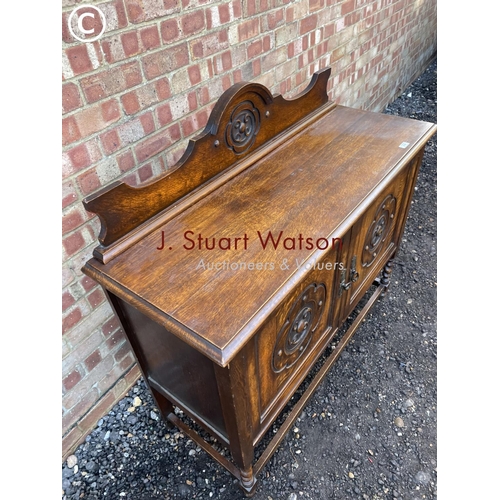 56 - A carved oak sideboard