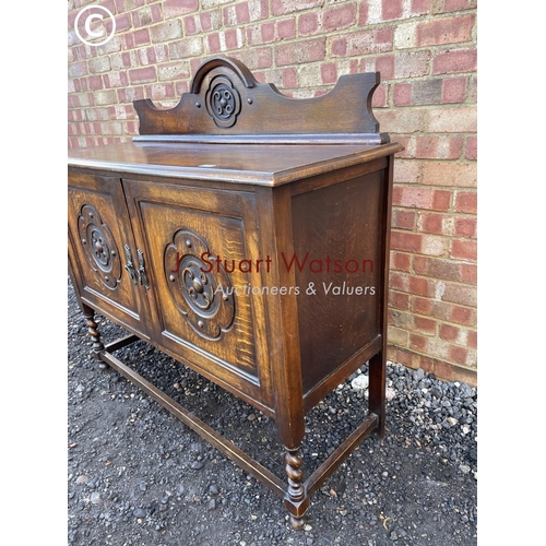 56 - A carved oak sideboard