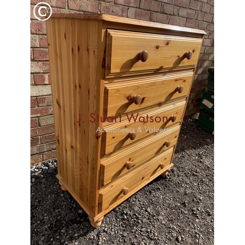 61 - A solid pine chest of five drawers