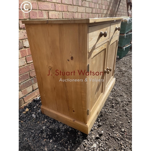 67 - A farmhouse style pine two drawer sideboard