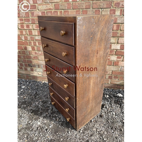 70 - A ply wood tallboy chest of seven drawers