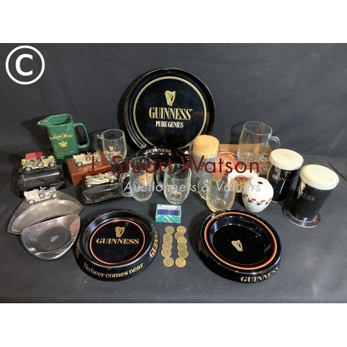 748 - Guinness advertising items and tokens, car ashtrays a/f and advert water jug