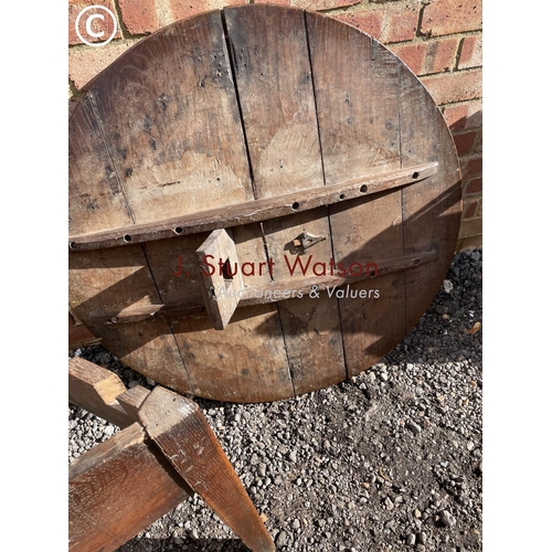 77 - An antique oak three legged cricket table