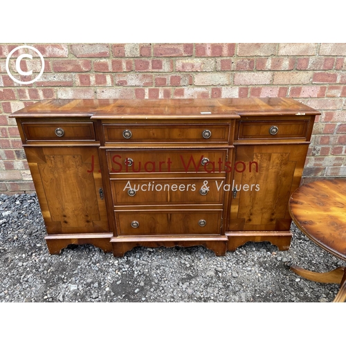 78 - A small yew wood break front sideboard together with matching occasional table