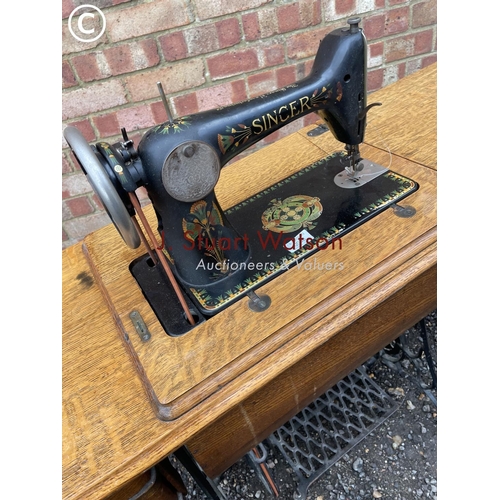 8 - A singer treadle Sewing machine with a cast iron base