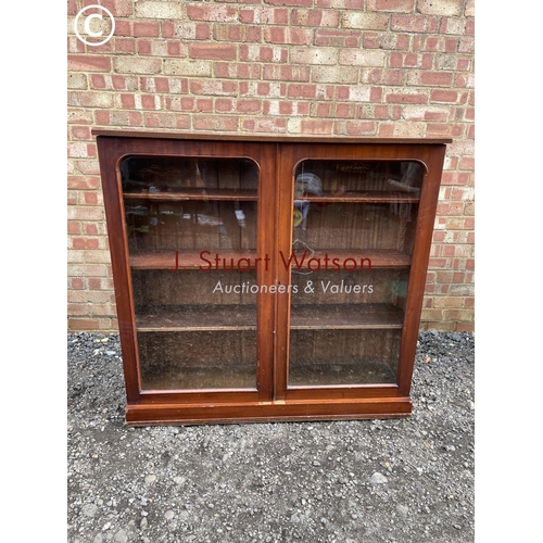 81 - A Victorian mahogany two door glazed bookcase with three adjustable shelves