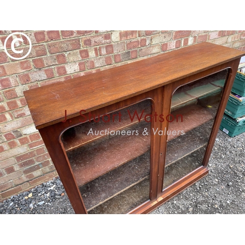 81 - A Victorian mahogany two door glazed bookcase with three adjustable shelves