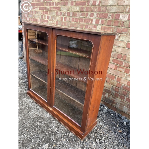 81 - A Victorian mahogany two door glazed bookcase with three adjustable shelves