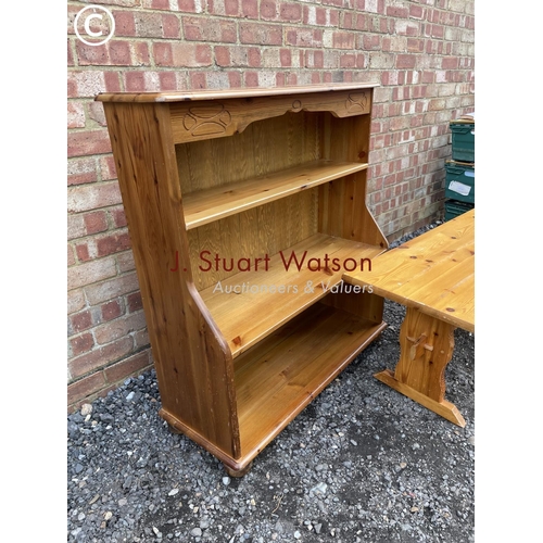 83 - An open pine bookcase together with a pine coffee table